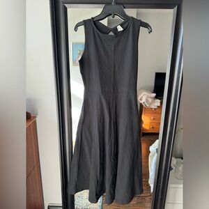 Black sleeveless cotton fit and flare midi dress from Pact with pockets!